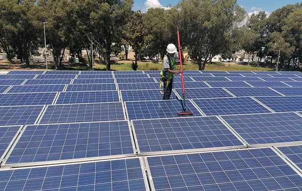 A technician cleaning a large ground array
