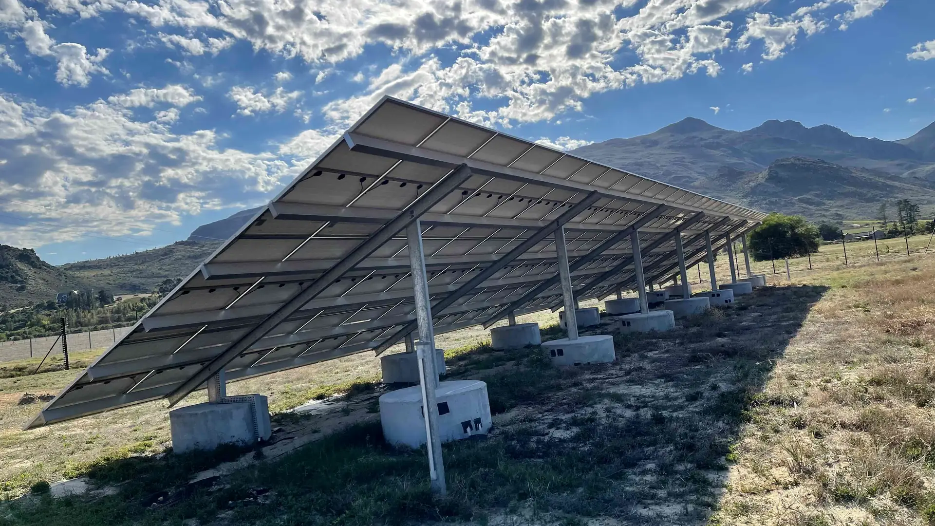 A ground-mounted solar array on a farm in a mountain valley